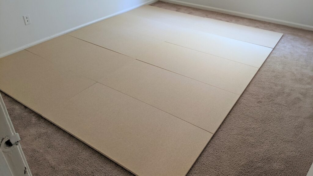 Ten 2x4 boards laid out on the floor | dance floor on carpet step 1