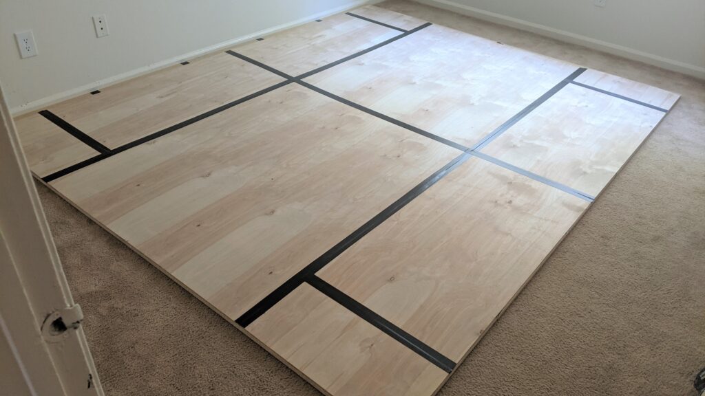 another layer of wood has been placed on top of the first and secured with duct tape | dance floor on carpet step 2