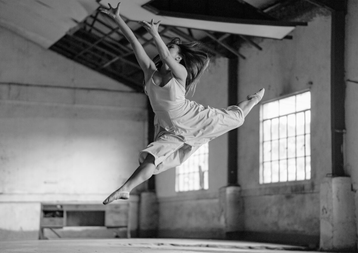 black and white photo of woman doing dance leap | how to jump higher for dancers